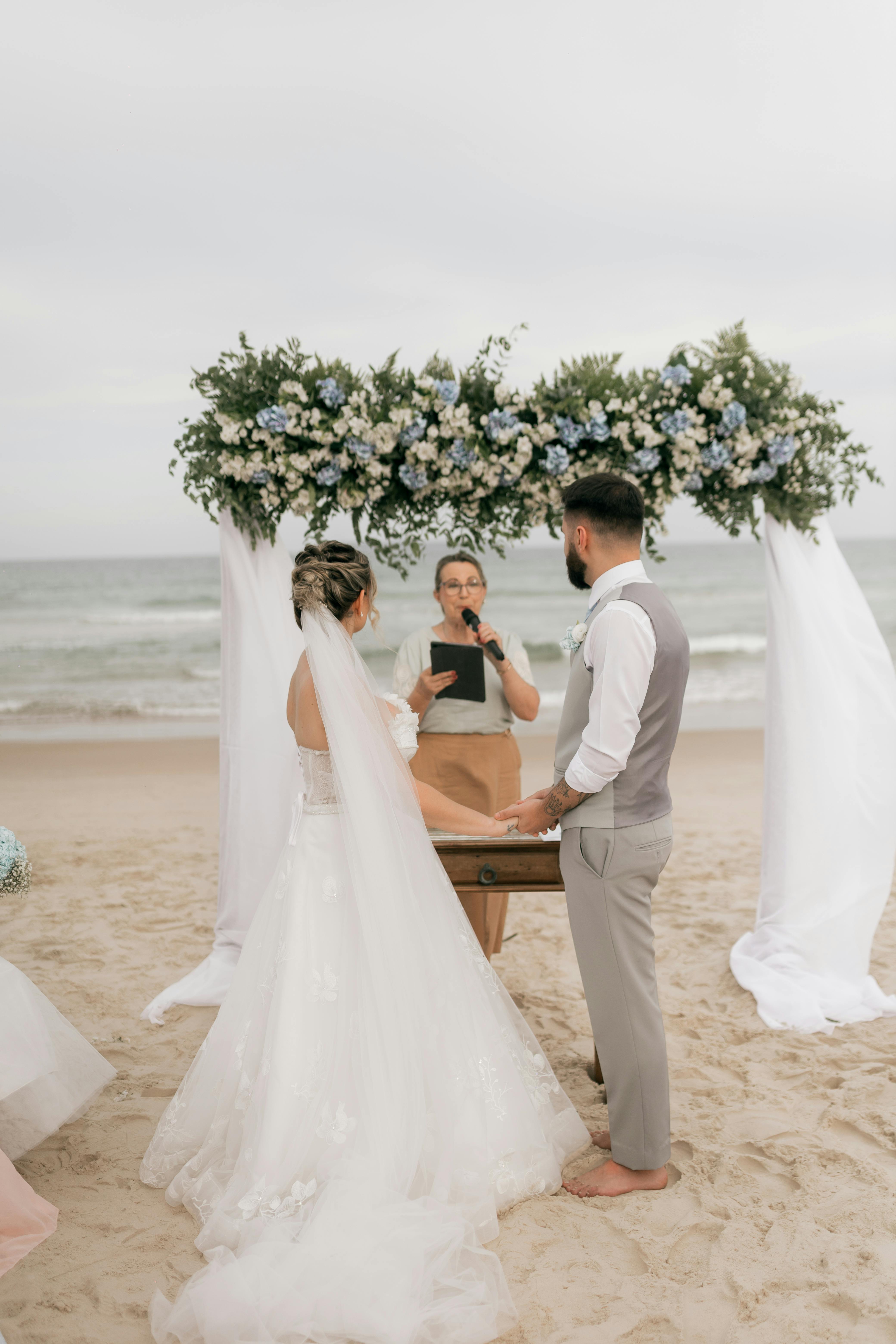 Bride and groom embracing under flowers